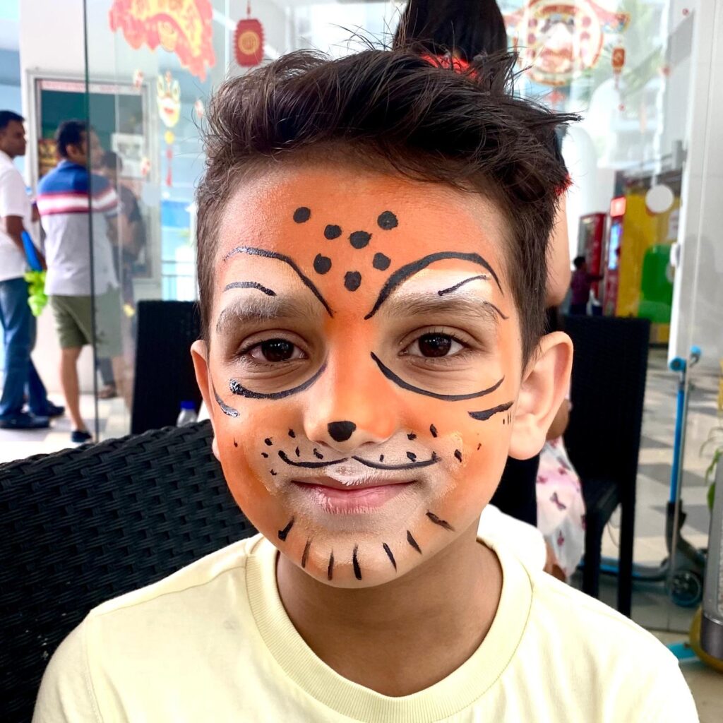 Facepainting for Children's parties by The Kindled Collective - leopard design on face - birthday party themed face painting