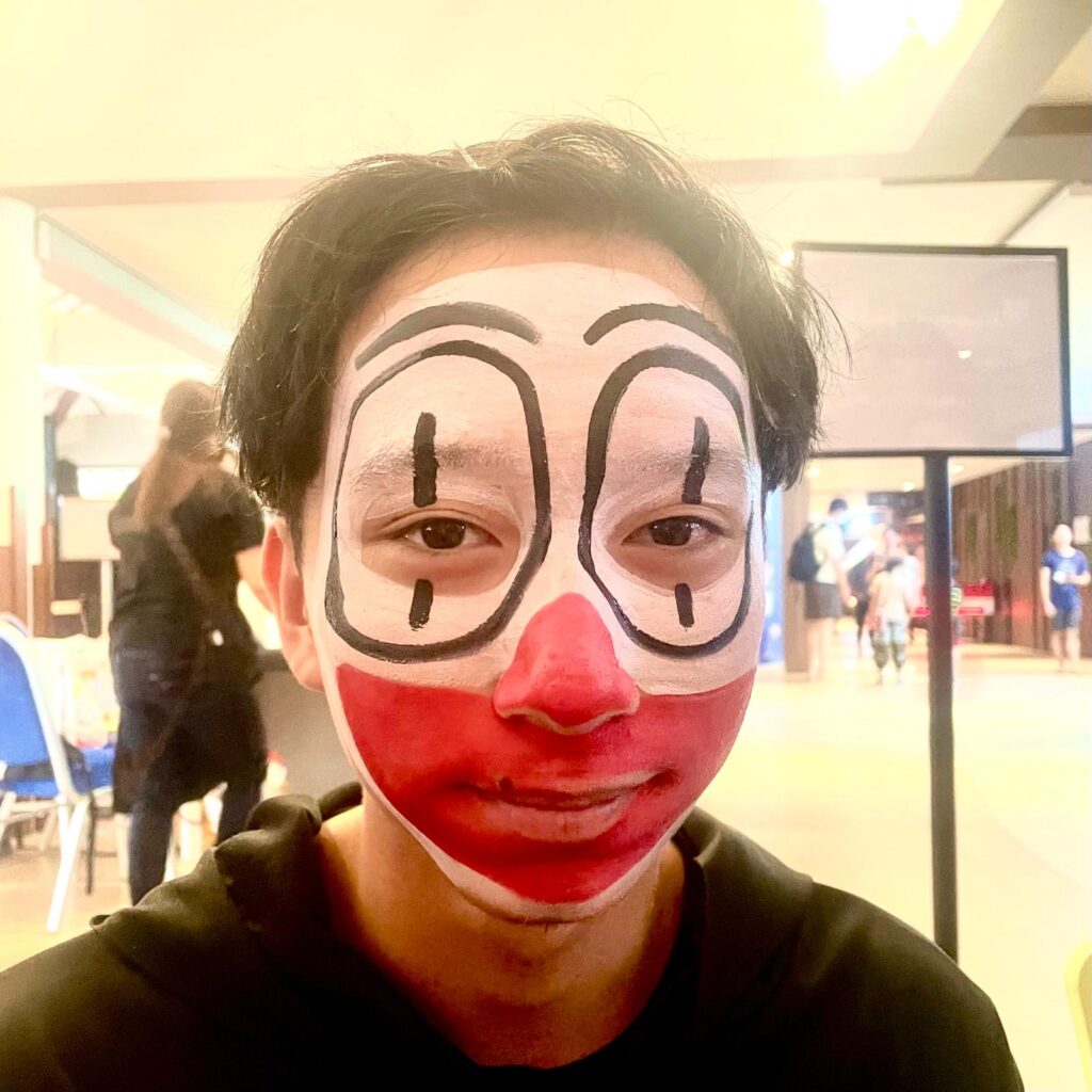 Facepainting for Children's parties by The Kindled Collective - clown jester design on face - halloween themed