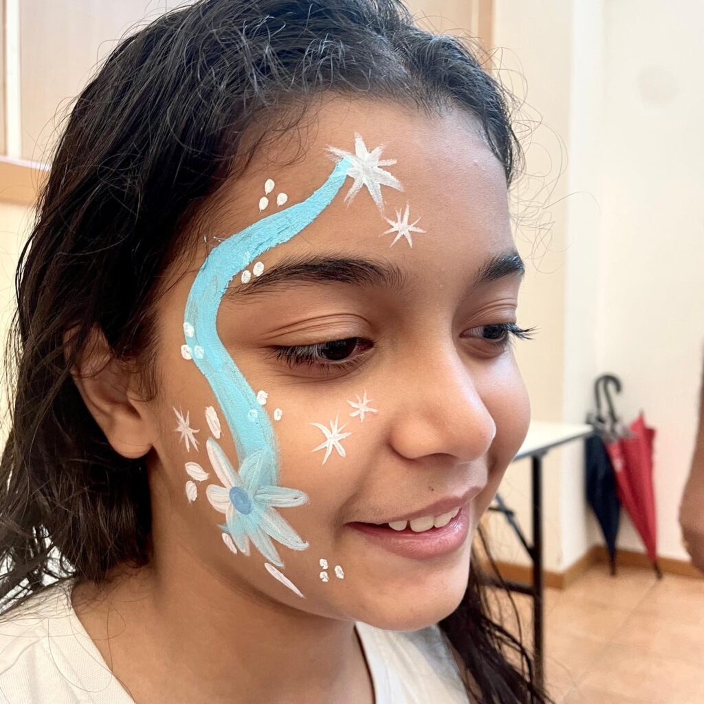 Facepainting for Children's parties by The Kindled Collective - blue floral design on face