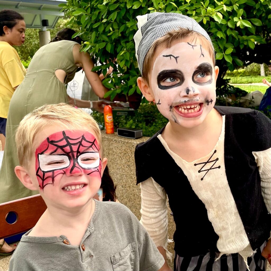 Facepainting for Children's parties by The Kindled Collective - halloween themed spiderman and skull design on face