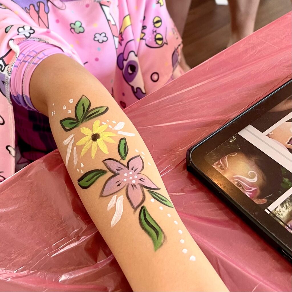 Facepainting for Children's parties by The Kindled Collective - flower design on forearm