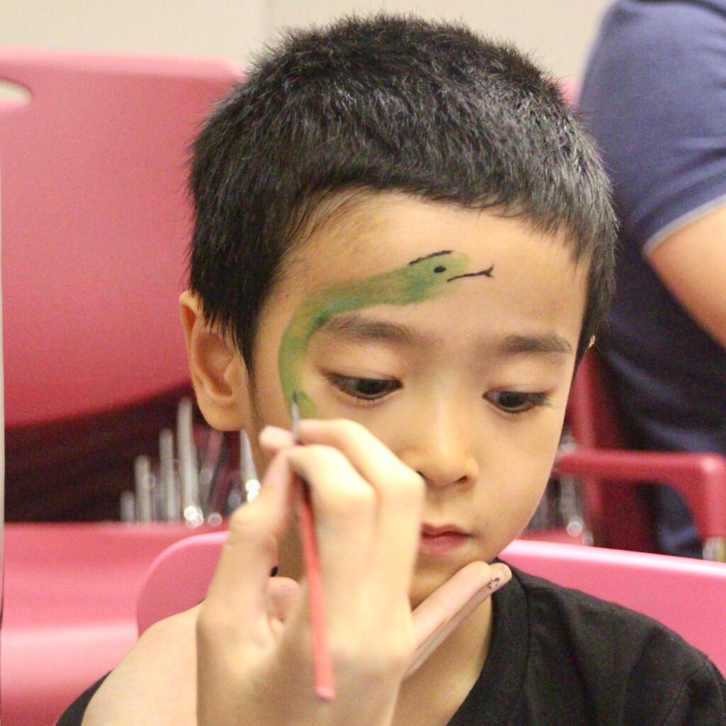 Facepainting for Children's parties by The Kindled Collective - snake on a face