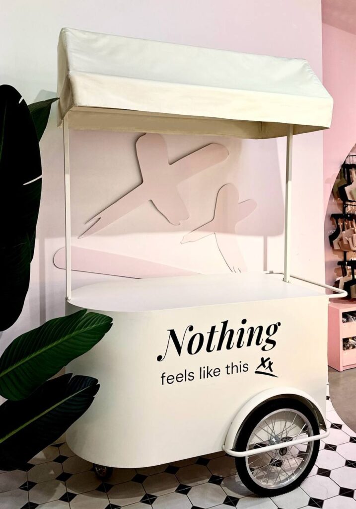 Off-white mobile pushcart with canopy roof, comes with large storage compartment. Fully customisable from cart body wrapping, simple logo customisation to printing of logo on the cart roof. Our pushcart is available in both black and off white. Perfect for reception tables, product displays, coffee cart, flower bars, or as a centerpiece to any event.