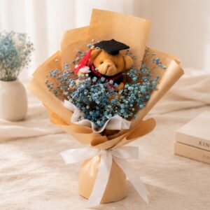 A bundle of dried baby’s breath with a mini graduation bear! Suitable for both guys and girls. Blue dried baby's breath wrapped in rustic brown kraft paper with white ribbon. Topped off with a graduation bear in either white or brown!