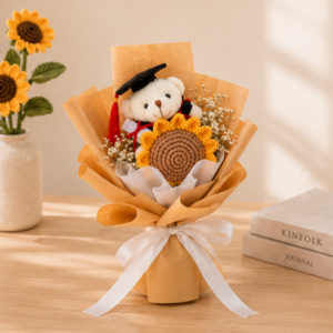 A graduation bouquet featuring a handcrafted crochet sunflower, delicate white limonium, and a mini graduation bear! A sweet keepsake that's perfect for celebrating their special day.