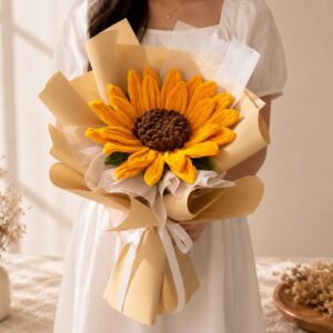 A graduation bouquet featuring an oversized handcrafted crochet sunflower! A bright and cheerful keepsake that's perfect for celebrating their special day.